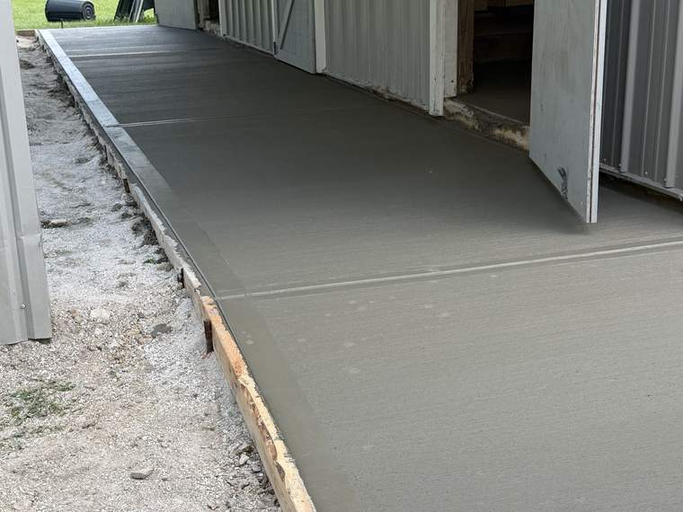 Concrete apron poured at the entrance to a pole barn