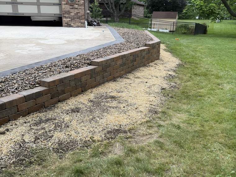 Long block retaining wall running the length of a driveway